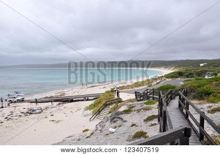 HAMELIN BAY,WA,AUSTRALIA-JANUARY 17,2016: Elevated view from boardwalk of people and boat launch ramp with turquoise Indian Ocean waters under stormy skies in Hamelin Bay, Western Australia.