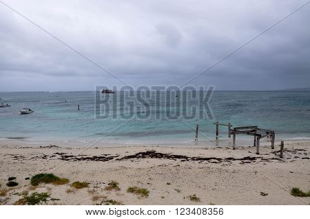 HAMELIN BAY,WA,AUSTRALIA-JANUARY 17,2016: People and Jetty ruins on the turquoise Indian Ocean coast line during a stormy day in Hamelin Bay, Western Australia.