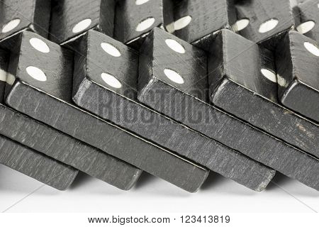Composition of lying black domino bricks with white dots