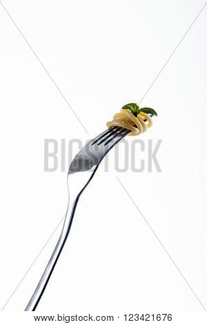 Pasta on fork tines, garnished with basil leaf