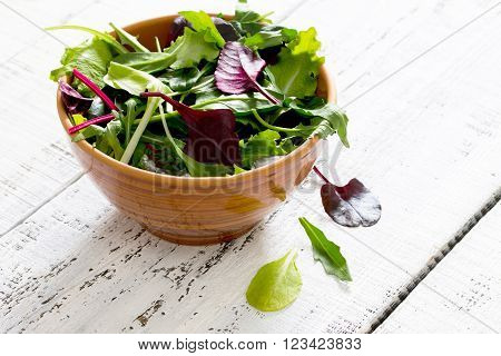 Fresh Green Mixed Salad In A Bowl On A White Wooden Table