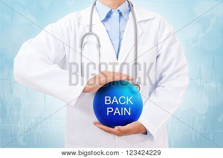 Doctor holding blue crystal ball with back pain sign on medical background.