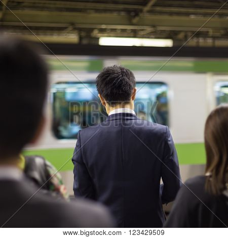 Passengers traveling by Tokyo metro. Business people commuting to work by public transport in rush hour. Shallow depth of field photo.
** Note: Soft Focus at 100%, best at smaller sizes