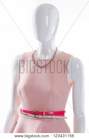Belts and necklace on mannequin. Female mannequin with glamorous accessories. Bright dress belts and necklace. Woman's jewelry and dress belts.