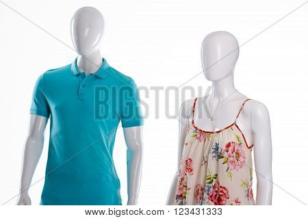 T-shirt and sarafan on mannequins. Mannequins in casual summer clothing. Men's polo and woman's sarafan. Casual clothes sale.