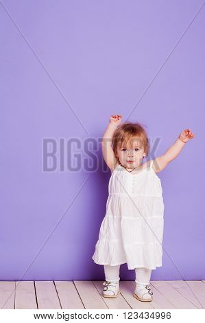 little girl in a white Sarafan in studio
