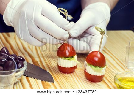 cook prepares canapes in the kitchen at the restaurant
** Note: Shallow depth of field