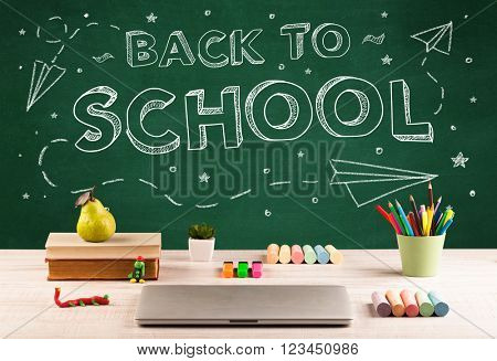 Back to school concepty with writing on blackboard and desk, apple, books, items