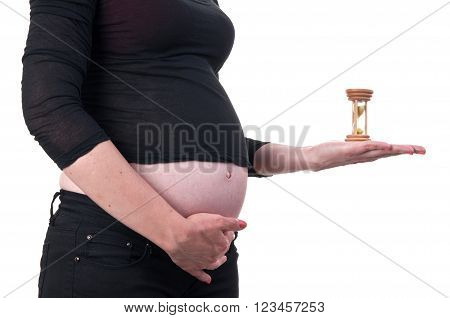 Image Of A Young Pregnant Woman Holding An Hourglass Next To Her Belly