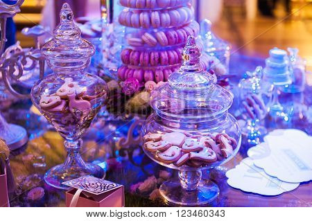 eco-friendly French makarons cake on the table. With purple lighting