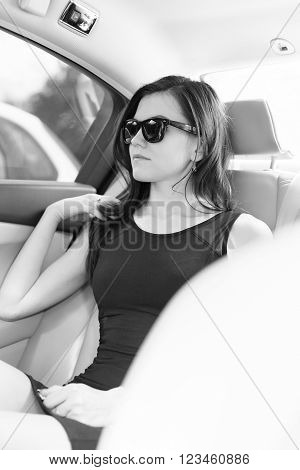 beautiful business woman in the car with glasses