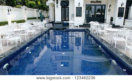 THAILAND, PATTAYA, MARCH, 29, 2015 - Gullivers is an Irish-style restaurant at the quiet end of Beach Road in Pattaya, Thailand. Guests can eat in the front courtyard around the pool, if there is a cool evening breeze.