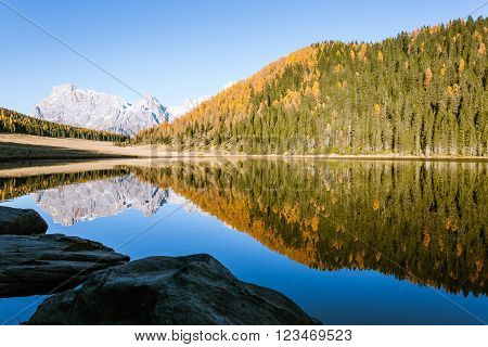 Mountain panorama from Italian Alps. Reflections on water from "Calaita" lake. Beautiful dolomites