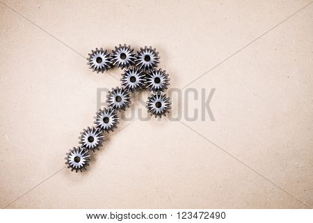 Indication concept. Mechanical components forming an arrow. Gears industrial objects