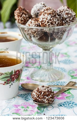 Homemade healthy vegan chocolate candy with coconut cereal and banana