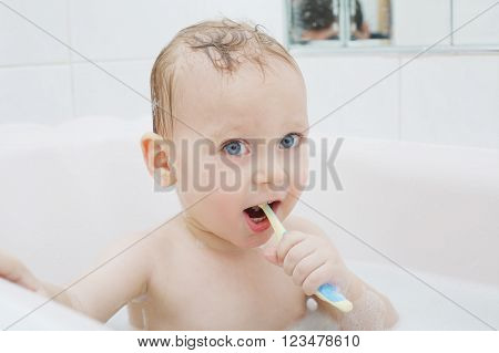 photo of little boy washing in bath