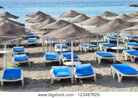 Chairs and umbrellas on Fanabe beach in Tenerife, Spain