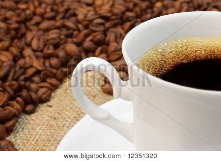 coffeecup against beans background