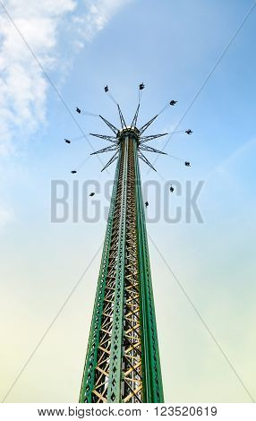 Vienna, Austria - April 27, 2011: 117 m (384 ft) high swing carousel in Wurstelprater, or simply Prater, amusement park in Vienna, Austria.panoramic city views.