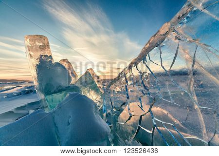 Surface of transparent fissured black ice of The Baikal Lake in winter