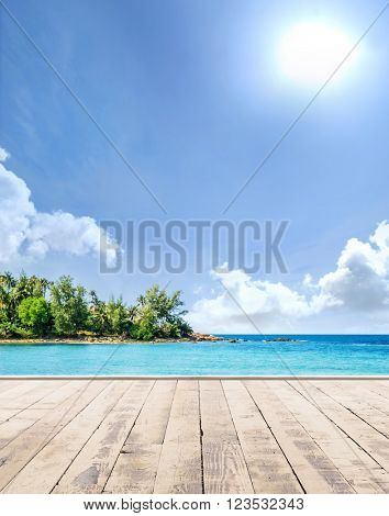 Wooden pier, exotic sea and a blue sky. Beautiful summer background. Vacation and traveling concept.