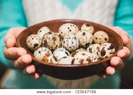 quail eggs are on the brown table in the hands,Easter,Food,Cook,Kitchen,Healthy,Organic