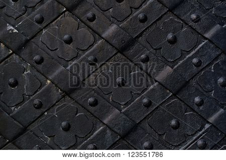 Dark gray door made of wrought iron