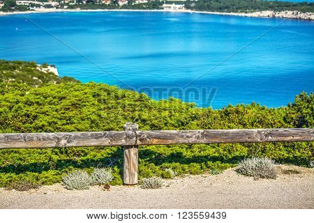 a wooden guardrail in Capo Caccia in Italy