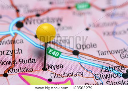Photo of pinned Nysa on a map of Poland. May be used as illustration for traveling theme.