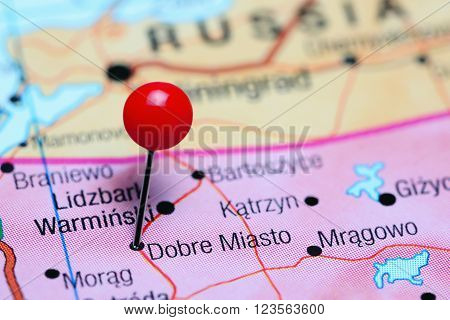 Photo of pinned Dobre Miasto on a map of Poland. May be used as illustration for traveling theme.