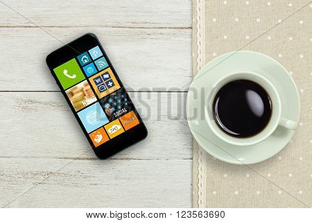 Coffee cup and Mobile phone on wood table with Social Media concept.