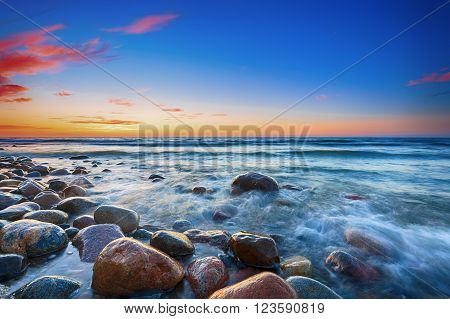 Sunset over the Baltic sea. The pebbly beach in Rozewie. HDR - high dynamic range