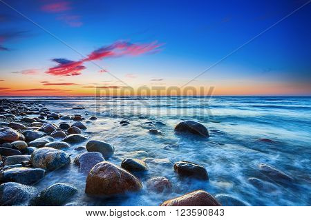 Sunset over the Baltic sea. The pebbly beach in Rozewie. HDR - high dynamic range