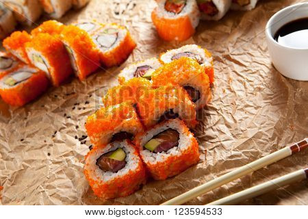Maki Sushi with Masago  - Roll made of Fresh Raw Salmon, Avocado inside. Masago (smelt roe) outside