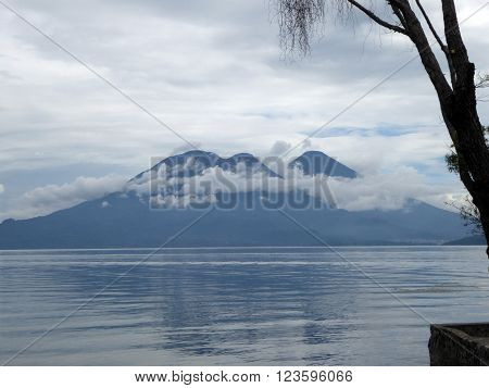 The volcanoes Toliman and Atitlan visible over the crater lake Lake Atitlan in Guatemala.
