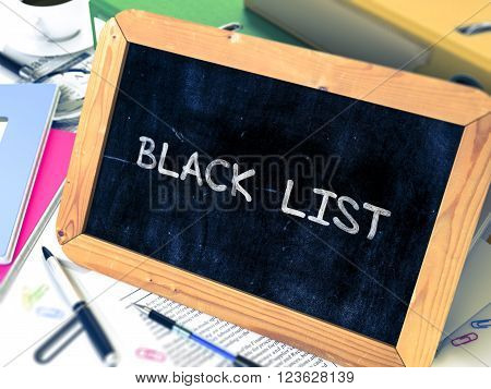 Black List Concept Hand Drawn on Chalkboard on Working Table Background. Blurred Background. Toned Image. 3D Render.