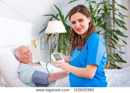Loving Caregiver Measuring Blood Pressure