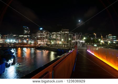 City lights across bay around illuminated walkway Wellington New Zealand