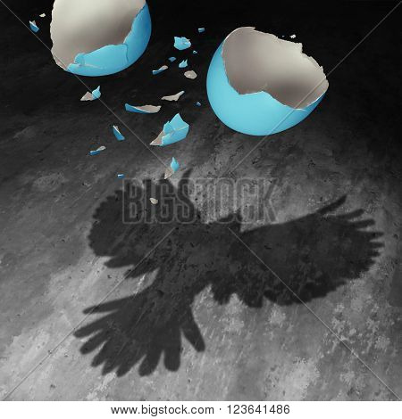 Concept of freedom as a falling broken egg shell in the air creating a cast shadow of a bird with open wings as a positive motivation metaphor for transformation success and determination to succeed.