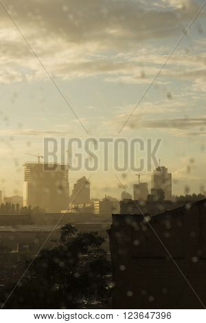 Urban view through the window after rain