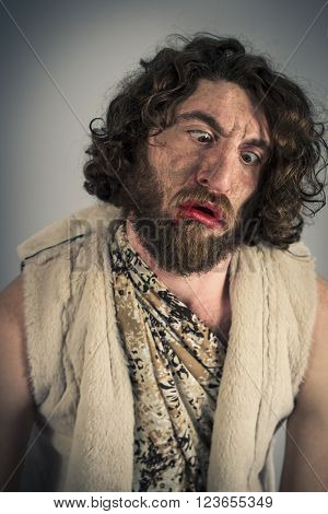 Silly realistic caveman with dirty face and crossed eyes