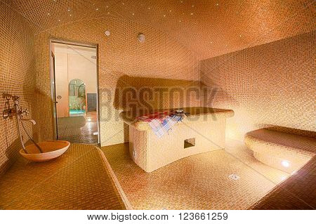 Interior of Turkish sauna, classic Turkish hammam at spa center. Spa, relaxation and resort health care center interior. Decorated in golden colors. Eastern hammam.