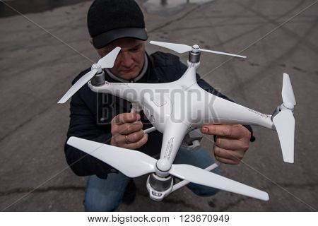 Saint-Petersburg, Russia - March 26, 2016: People learn to control unmanned aerial vehicles - drones with the help of experienced users Phantom Series device