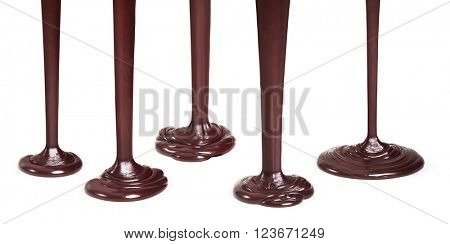 Flowing dark chocolate isolated on white background