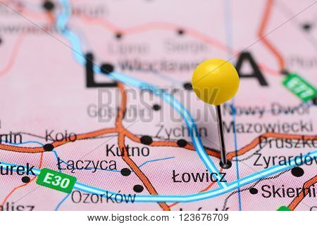 Photo of pinned Lowicz on a map of Poland. May be used as illustration for traveling theme.
