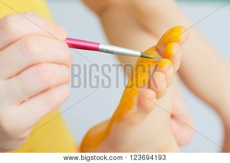 Caucasian child foot painting for bright color festival
** Note: Soft Focus at 100%, best at smaller sizes
