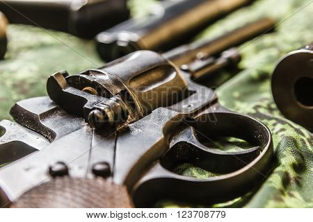 Detail shot of vintage generic russian soviet 9mm pistol on pixel camouflage background