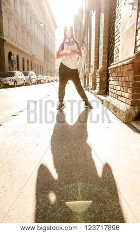 A beautiful young Hip Hop Rapper girl with Headphones in a urban environment.