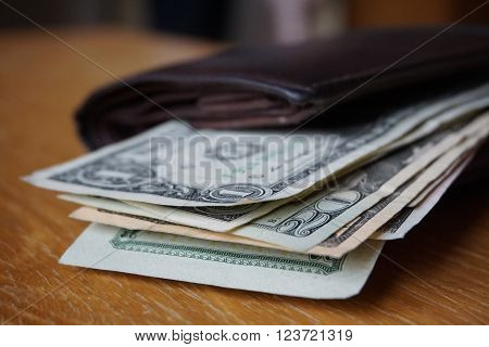 Detail of the American money (USD, US, US dollars), bank notes inserted in the leather wallet