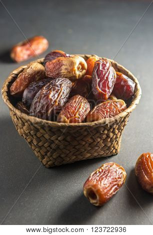 Fine quality arabic dates arranged in an earthen bowl.